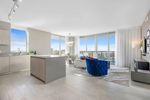 Bright modern condo with floor-to-ceiling windows and skyline water views