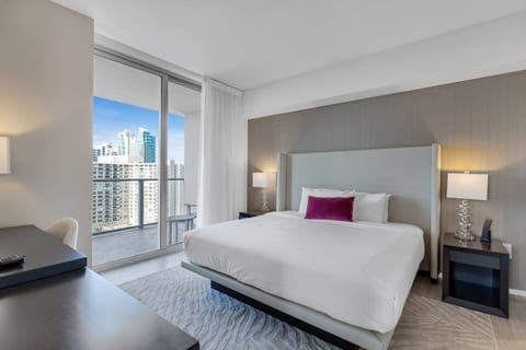 Step into the master bedroom, featuring a plush king-size bed, private bathroom, and direct access to the balcony. A dedicated workspace adds comfort and convenience.