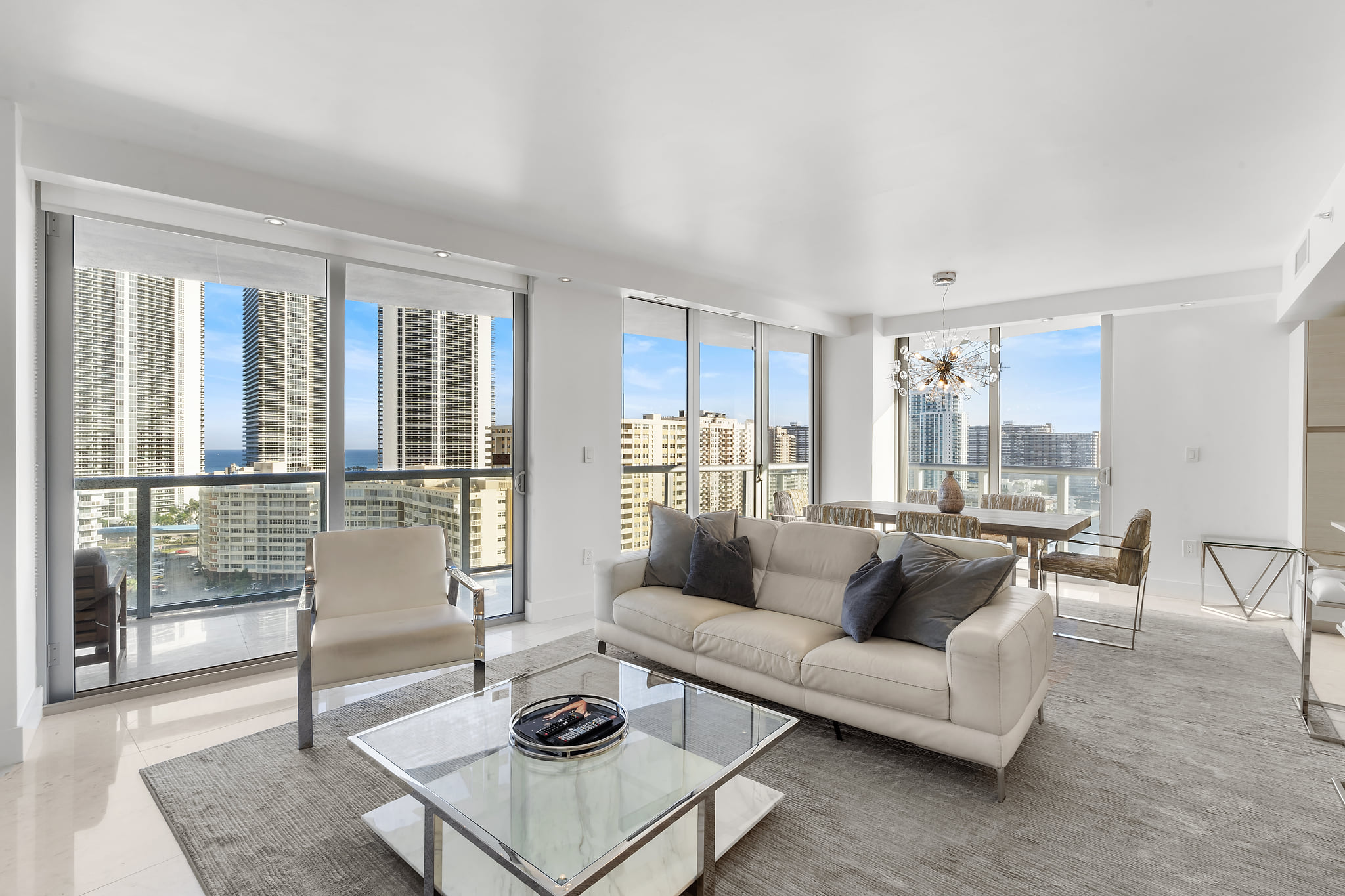 Sleek high-rise condo with floor-to-ceiling windows and skyline views.