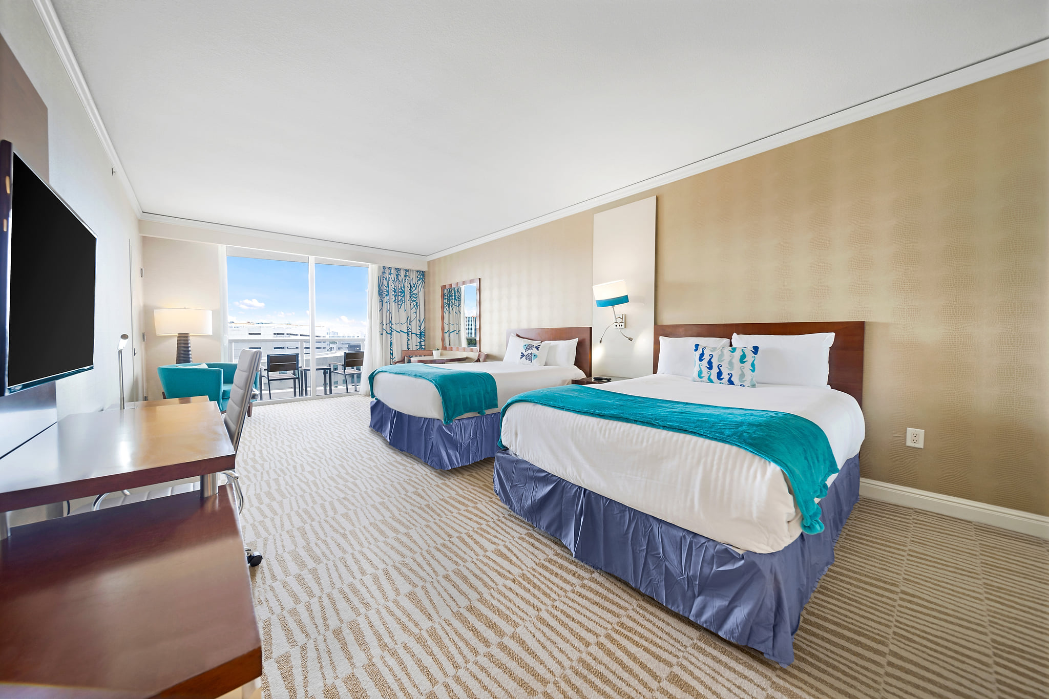 Spacious double-queen room with balcony and ocean views