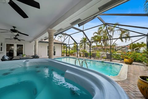 Relax and unwind in your private heated pool and hot tub, surrounded by tropical views and a fully screened patio for ultimate comfort and privacy.