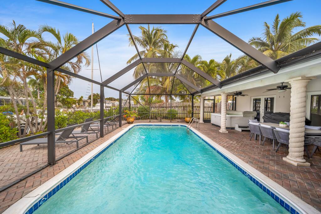 Lounge on the sunbeds, enjoy meals at the outdoor dining table, or unwind in the covered seating area with tropical views.