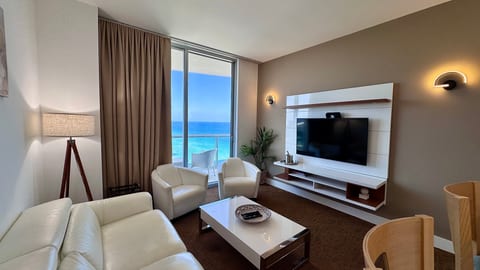 Ocean-view lounge with balcony, sleek media wall & plush seating