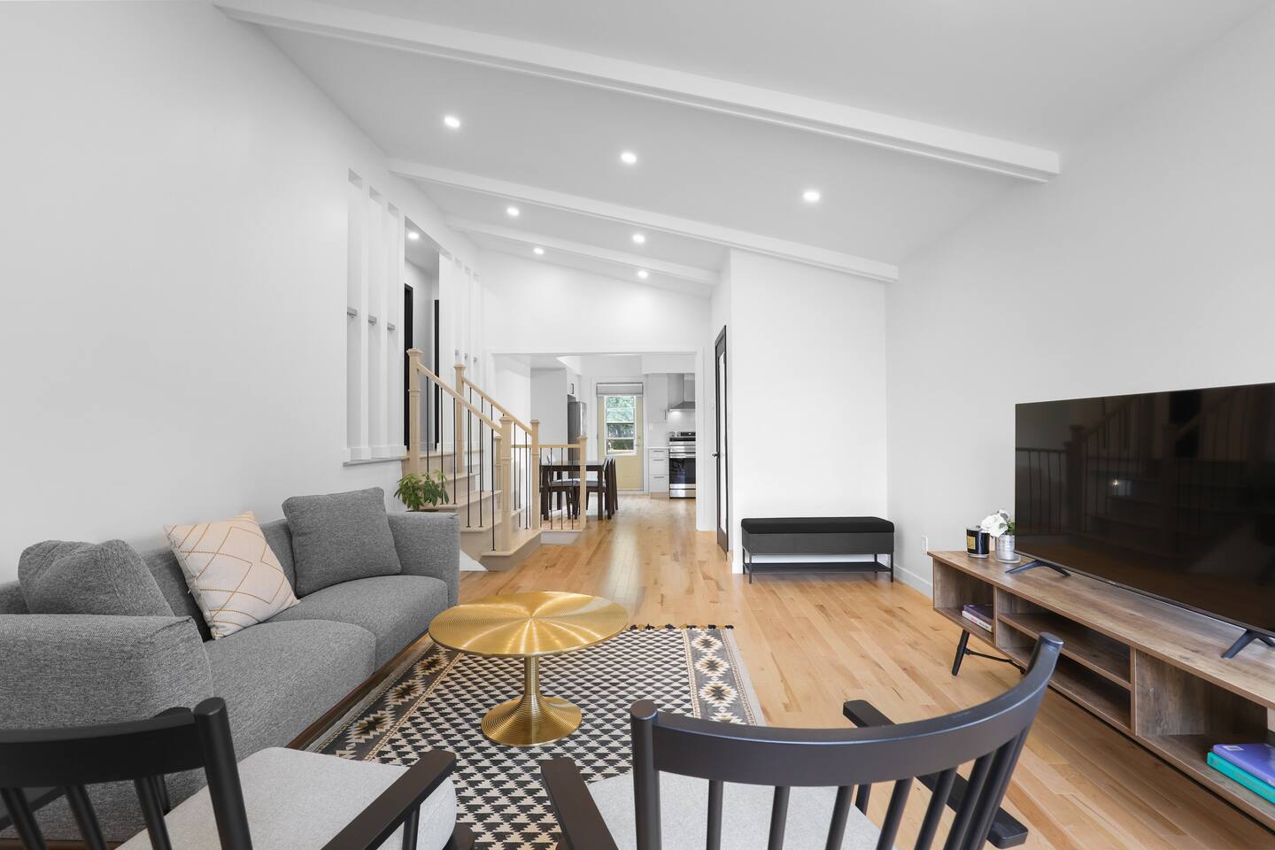 A different perspective of the spacious living room, showcasing its welcoming layout perfect for relaxing or entertaining.
