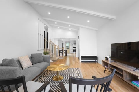 A different perspective of the spacious living room, showcasing its welcoming layout perfect for relaxing or entertaining.