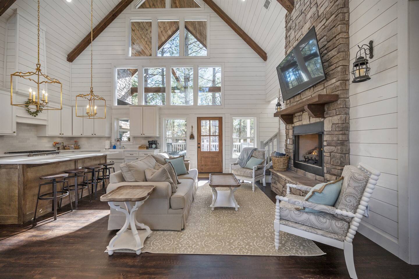 The great room has a vaulted ceiling with many windows making it a great spot to relax and enjoy your vacation.