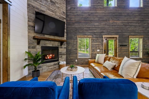 Comfort Meets Elegance: Plush couch, fireplace, and 75-inch TV await in your living room oasis