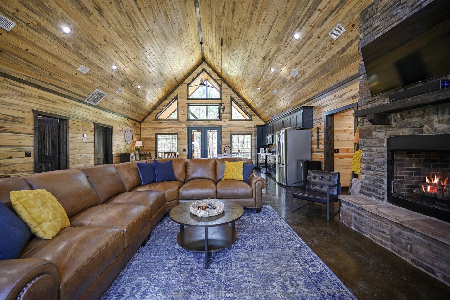 Embrace rustic elegance by the stone floor-to-ceiling fireplace, where warmth and charm meet in the heart of our living room.