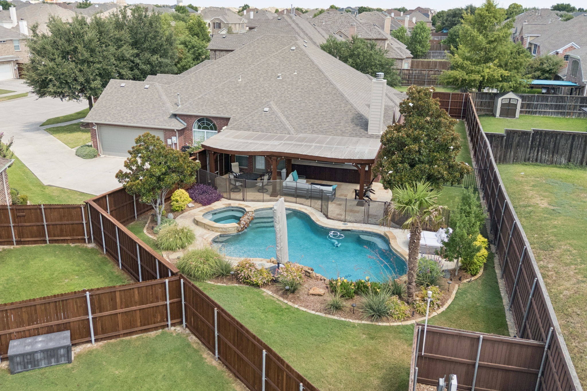 Aerial view showcasing the secluded pool, spa, and spacious backyard retreat. 