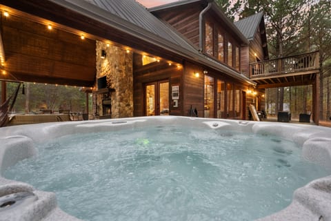 Immerse yourself in pure relaxation in this private hot tub, nestled on a spacious deck and enveloped by the peaceful sounds of the forest. Your ultimate escape awaits.