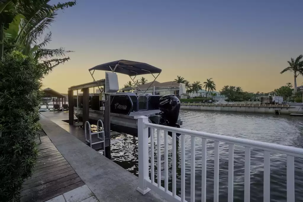 Boat docked behind house