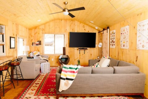 Living area with 70" TV and seating for 6 comfortably.