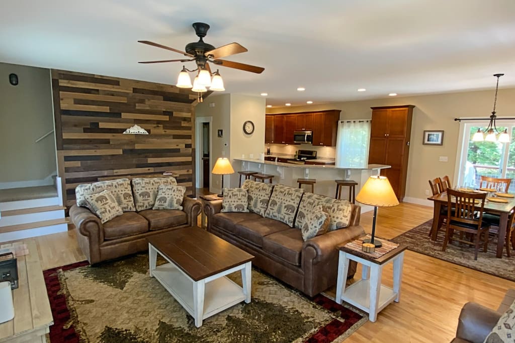 The living space looking in the direction of the kitchen. The motif we went with is rustic cabin with a hint of farmhouse. It's very cozy! - River Rock Cabin - Hendersonville, NC - Horse Shoe