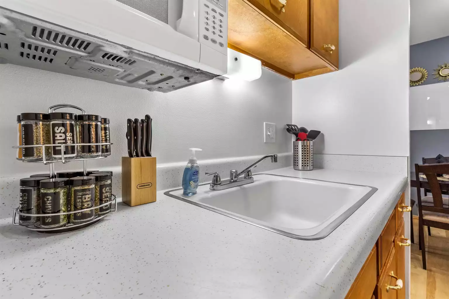 Knife block, spice rack, coffee, creamer, sugar and tea.