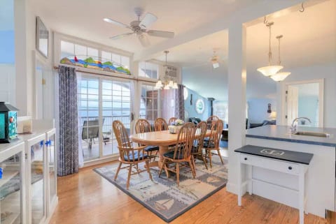 View from entrance door. Dining/kitchen area out to balcony with beach view.