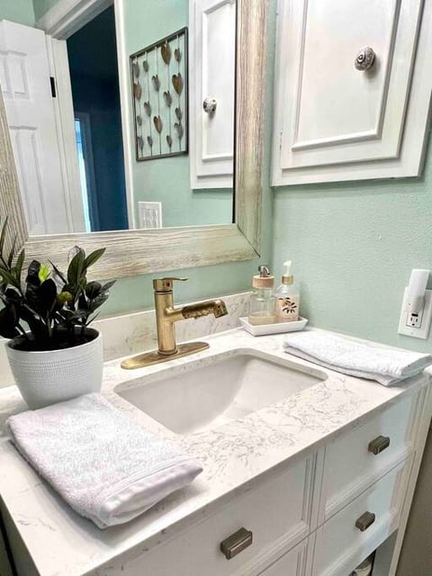 The main bathroom is off the hallway and includes a jacuzzi-type soaking tub with a shower.