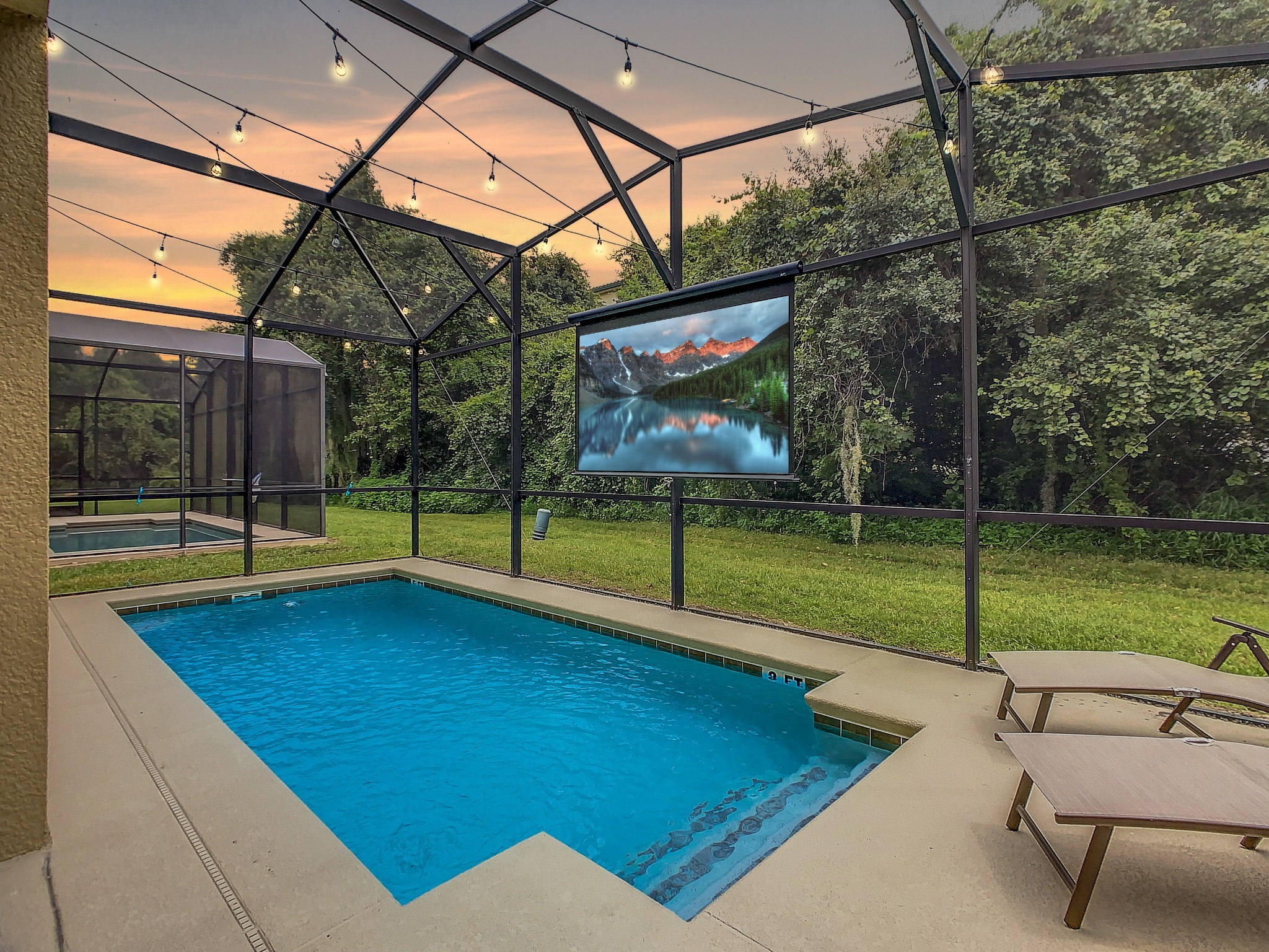 Enjoy an evening movie from the pool (additional fee applies. Inquire for more details).  *photo edited to better demonstrate movie screen and outdoor lighting. - 5mi Disney* Immersive Themes* Outdoor Pool & Movie - Kissimmee