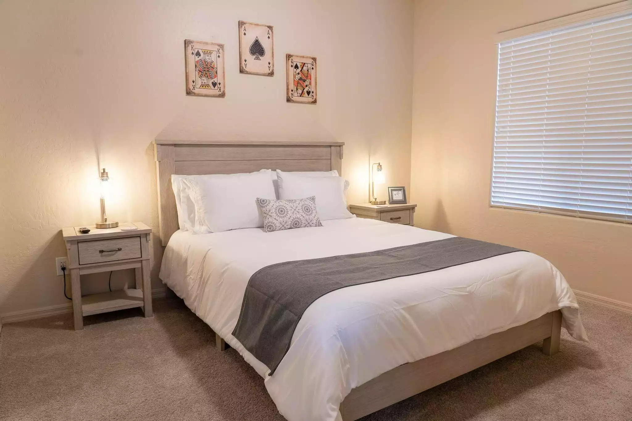 Bottom floor bedroom - Queen bed, two nightstands, lamps with USB ports, wall mounted smart TV, closet with shelves - 5 Bed 3 Ba house w/ PRIVATE SALT POOL & EV Charger - Henderson