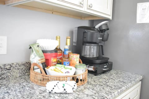 Grab your morning hot beverage from the coffee station with dual Keurig that includes  drip coffeemaker with an unusually large assortment of coffee supplies.