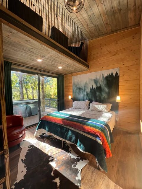 Second bedroom with king bed, access to the deck and a loft play area