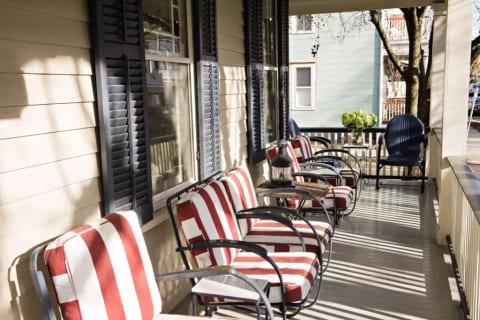 Chadwick Cottage Vacation Rental Home. Front porch with vintage Wolfgang Hoffmann Springer Chairs from Howell. Vacation Rentals Asbury Park. Vacation Rentals Ocean Grove.