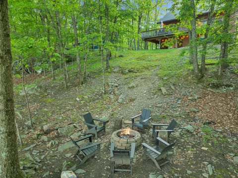 Serene outdoor fire pit area nestled in a quiet area of the woods, lakefront s'mores at its best!