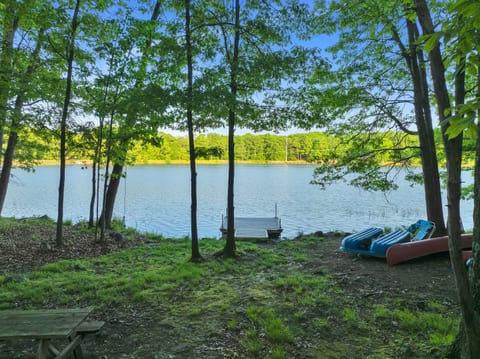 Lakeside bliss: a serene dock, boats ready for adventure, and the tranquil beauty of the Poconos!