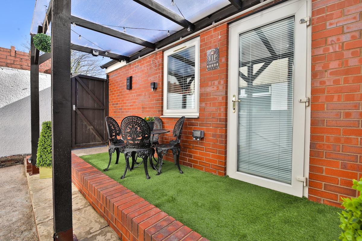 Our patio area under a pergola with a table and chairs