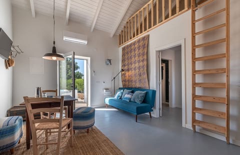 An inviting living space with soft blues and natural textures, where vintage details meet plenty of natural light.