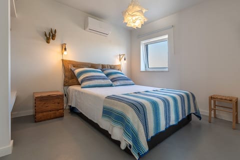 [Bedroom 1] A calm retreat with soft blues and crisp whites, where natural lights fills the space for a fresh and airy feel.
