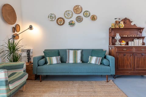 An inviting living space with soft greens and natural textures, where vintage details meet plenty of natural light.