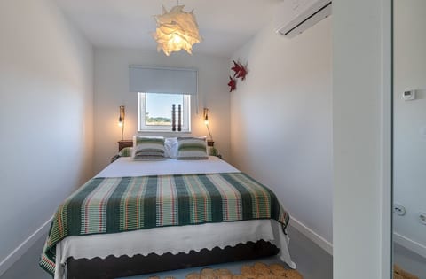 [Bedroom 1] A calm retreat with soft greens and crisp whites, where natural light fills the space for a fresh and airy feel.