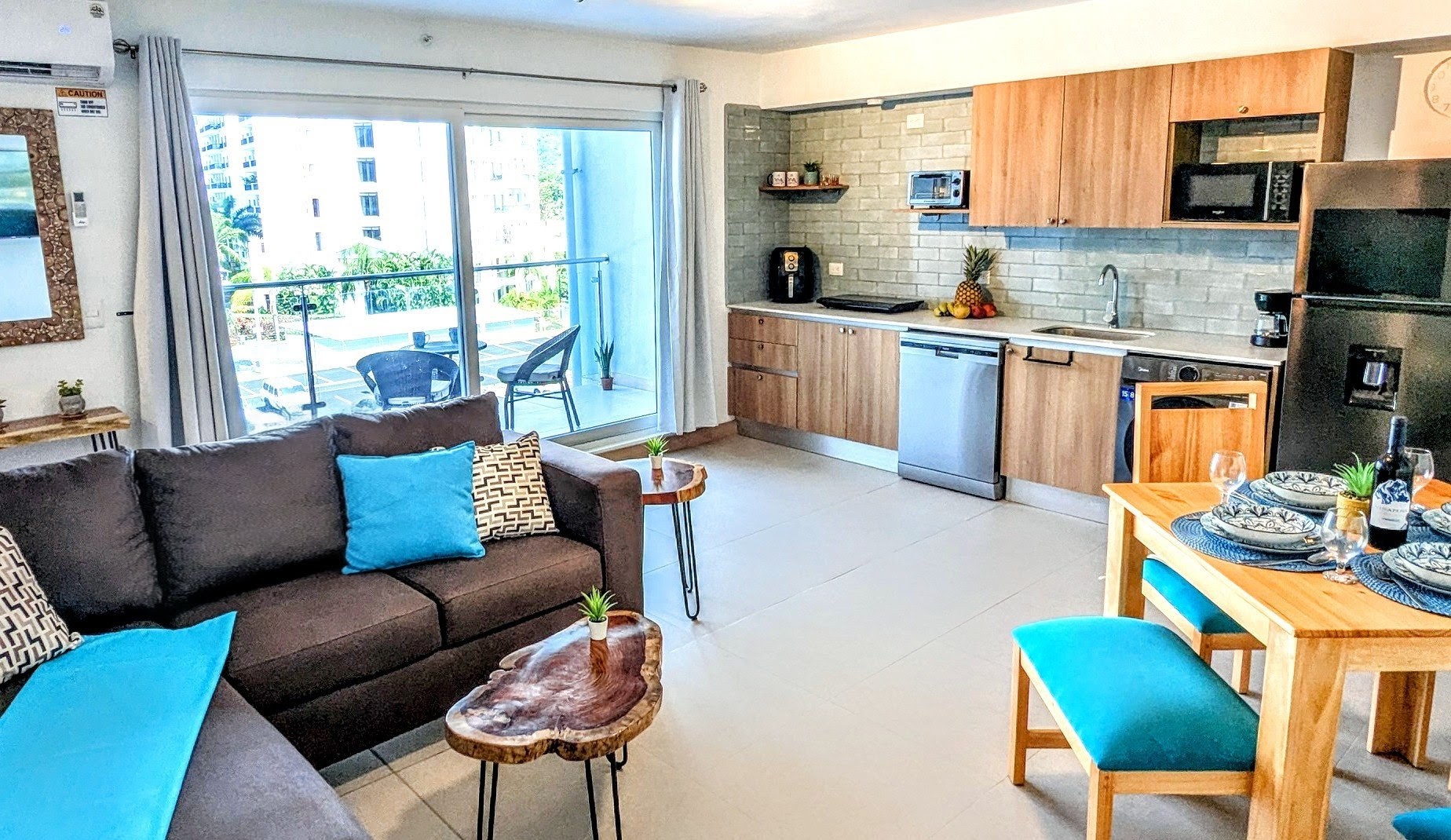 Comfortable combo room with lounge, dining table, and kitchen.