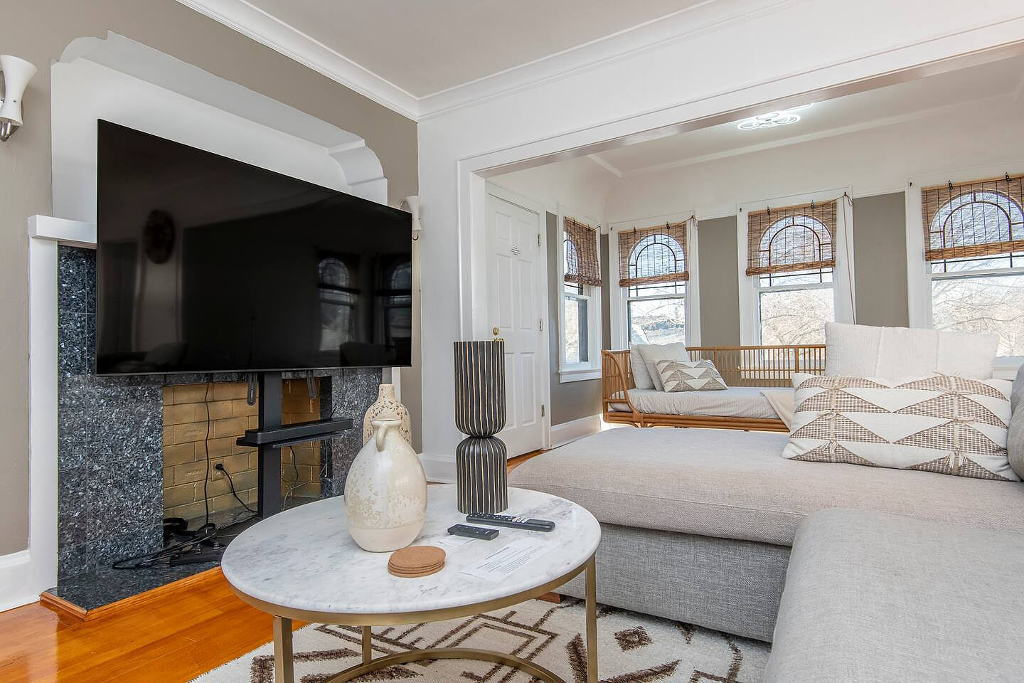 Living Room - Pull out couch bed, 75 inch Smart TV. Windows facing the street.