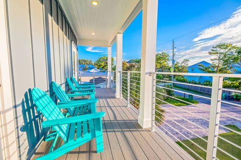 Enjoy morning coffee or sunset drinks from your private balcony—complete with Adirondack chairs and relaxing views of the neighborhood and nearby water.