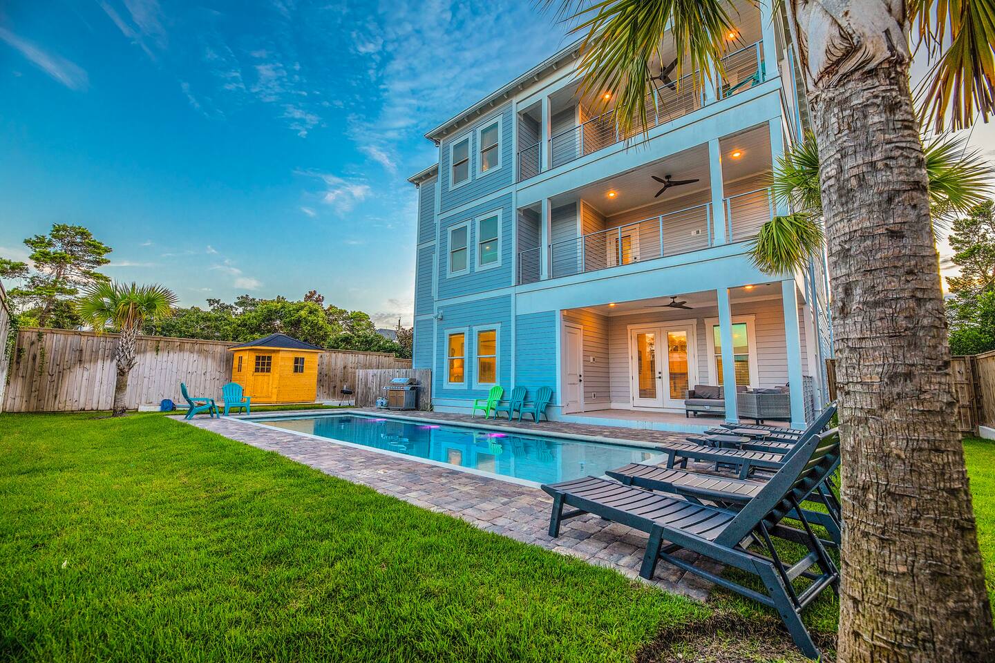 Experience resort-style living in this stunning 3-story home featuring a private heated pool, palm trees, multiple balconies, and plenty of outdoor seating—perfect for large groups looking to relax and enjoy Florida’s sunshine.