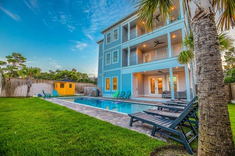 Experience resort-style living in this stunning 3-story home featuring a private heated pool, palm trees, multiple balconies, and plenty of outdoor seating—perfect for large groups looking to relax and enjoy Florida’s sunshine.