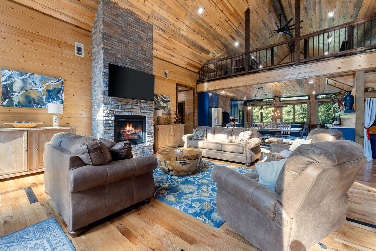 Cozy up by the stone fireplace in this luxury Broken Bow cabin. Soaring ceilings, warm wood finishes, and forest views create the perfect setting to unwind and make lasting memories.