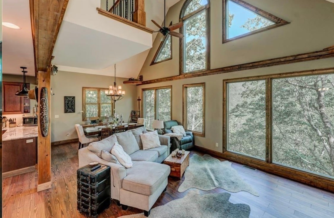 “The home is amazing, comfortable and felt like home..perfect for a weekend of peace and quiet. The waterfall behind the house is so serene, especially listening to at night” 

Wall of Windows overlooking waterfall , heart pine floors, exposed beams