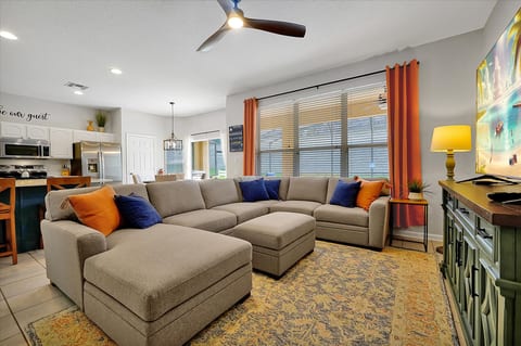 Family Room with comfy couch and 70" TV with Cable