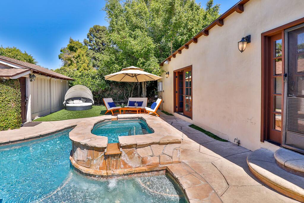 A heated pool complemented by an outdoor seating area, providing an ideal space for both entertainment and relaxation.