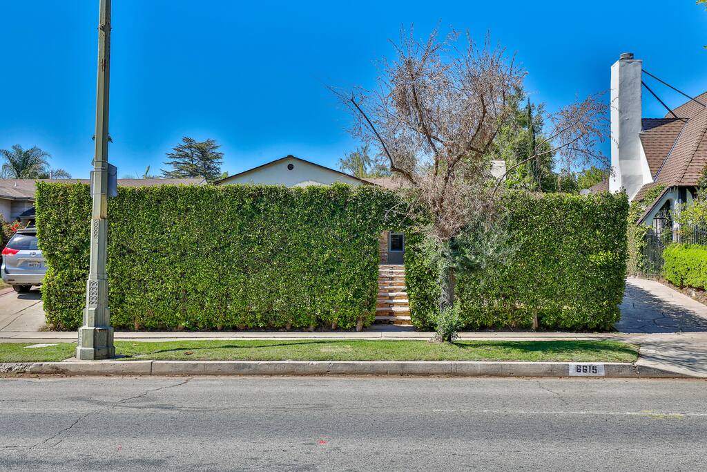 Stunning entrance enveloped by an enchanting garden to capture your heart.