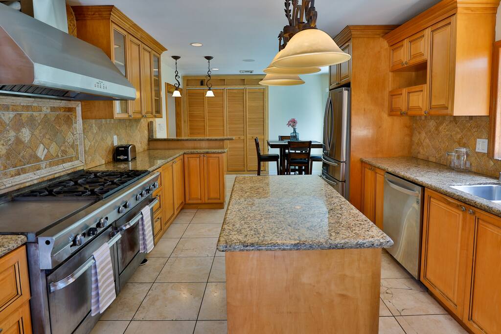 An upscale and fully-equipped kitchen with state-of-the-art appliances, meticulously crafted to enhance your culinary experience and create outstanding meals.