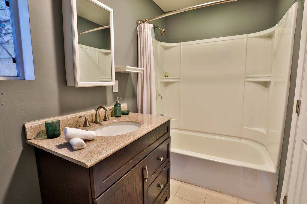 Guest house bathroom, with a tub and sink.
