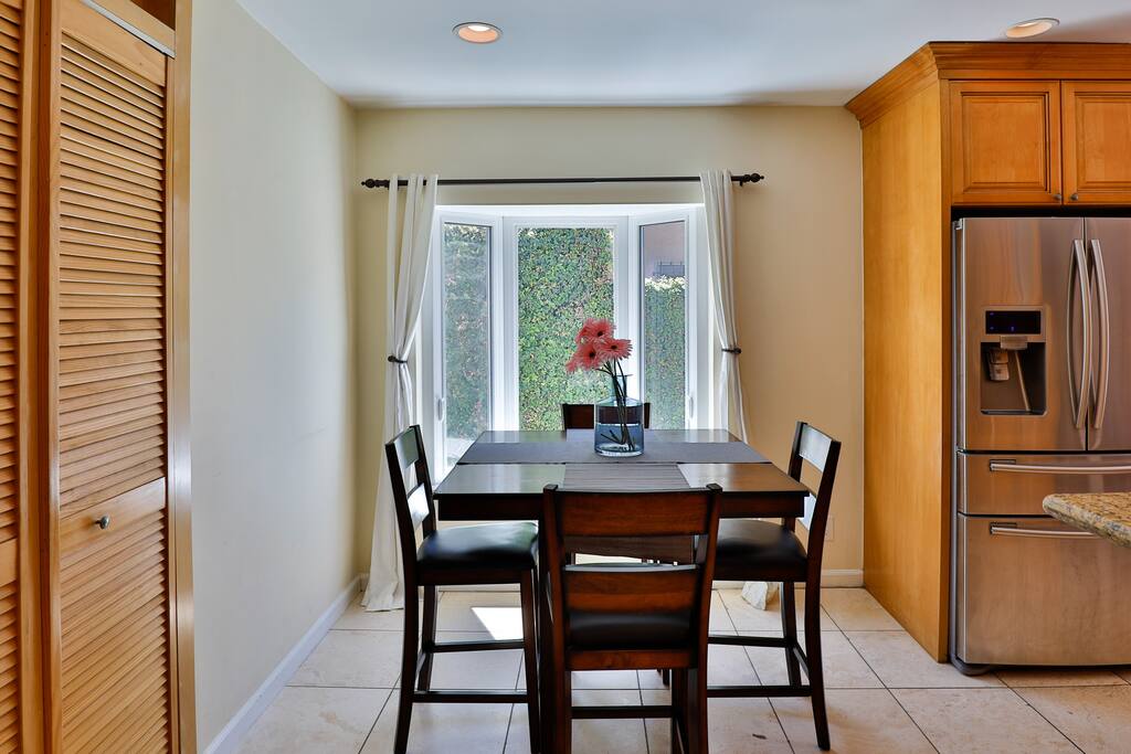 Generous dining area with breathtaking outdoor vistas, perfect for hosting exceptional meals and family or friend gatherings.