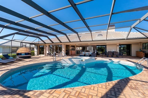 Outdoor lanai with heated, saltwater pool and hot tub