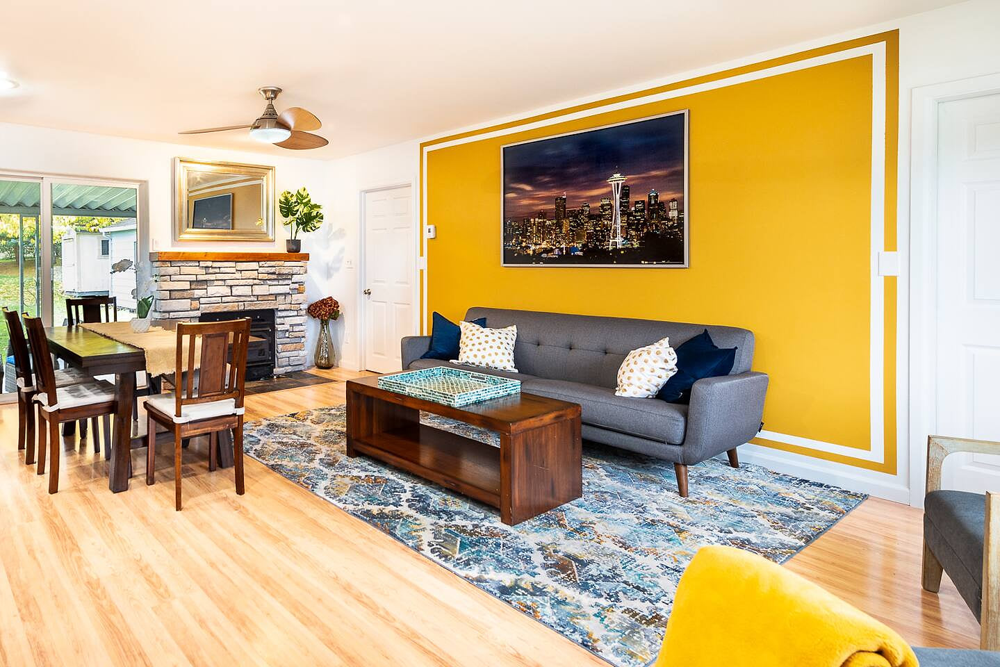 Our open concept living room is welcoming for families, kids, and pets. A wood burning fireplace is available for guest use. Firewood provided in the backyard.