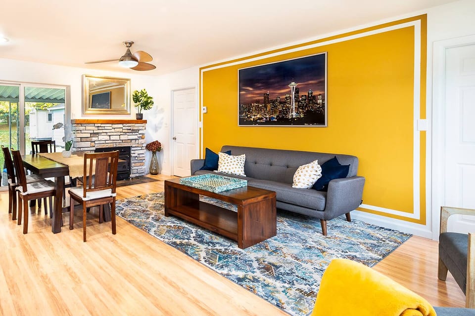 Our open concept living room is welcoming for families, kids, and pets. A wood burning fireplace is available for guest use. Firewood provided in the backyard.