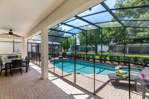 The outdoor table under the lanai seats 8 and the pool has a security fence