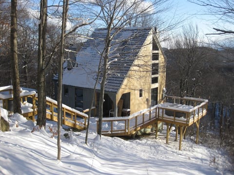 Exterior view of House. Stairs from Driveway and Deck. 